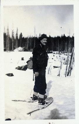 A man walking on snow with snowshoes