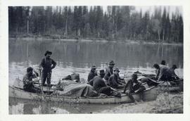 Several men resting in canoes