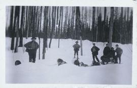 Several men standing around a dog sled