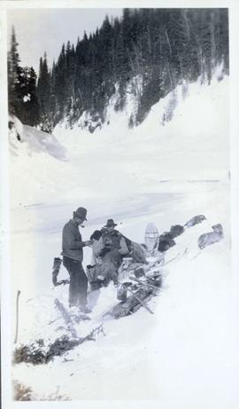 Two men and the dog sled team resting