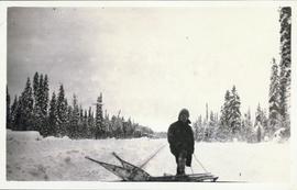 Man with snowshoes surrounded by snow