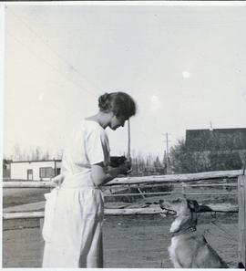 A woman playing with a dog