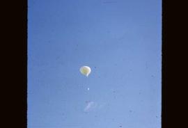 A weather balloon flying into the air