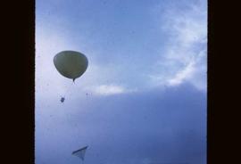 A weather balloon as its rising into the air
