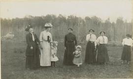 Several women and children standing next to each other