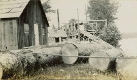 Large logs in front of a buildings and wood frame