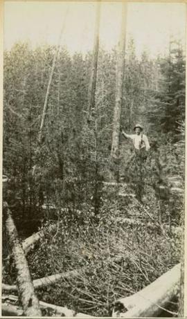A man standing next to a tree