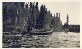 Man canoeing on a lake