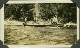 Three survey crewmen poling against the current in a boat