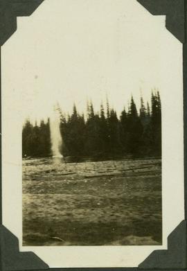 Column of water rising up into the air from blasting a log jam on a river