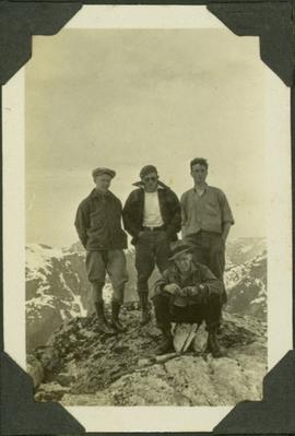 Four men on a rocky mountain top