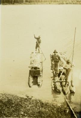 Survey crewmen on rafts on Thutade Lake