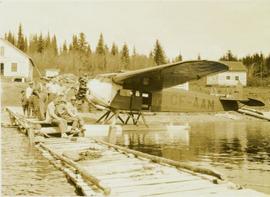 Group photo beside a floatplane on Takla Lake