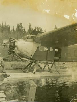 Man and floatplane at dock