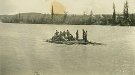 Thirteen men and supplies aboard a raft being pulled along Halfway River 