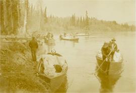 Survey crewmen in canoes along a lakeshore