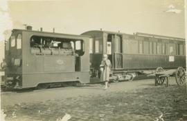 Unidentified man and woman standing beside a passenger train
