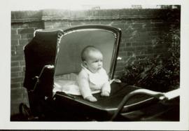 Family photographs from England: Baby John sitting up in his carriage