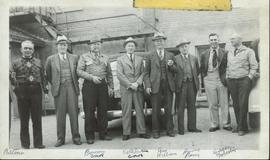 Harry Perry standing with a group of eight men
