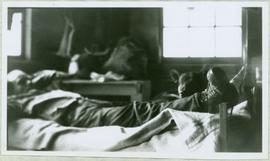Man and Dog Reclining in Bunkhouse