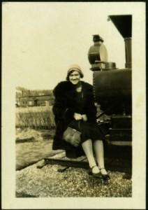 Violet Taylor Seated on Engine of Train