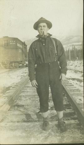 Unidentified man posing for a photo on the train tracks
