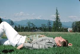 Gary Runka laying on grass at VanDusen Botanical Gardens