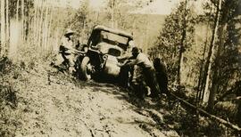 Men pushing a Citroen half-track along a muddy mountain path
