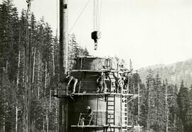 Workmen place last steel plates of Kamyr continuous digester