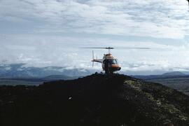 Helicopter on volcanic cone at Mount Edziza Provincial Park