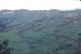 Caterpillar machinery at work on slope for mineral exploration at Ealue Lake