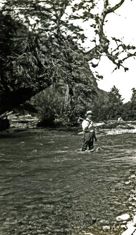 W.E. Collison standing in river at Kincolith, BC