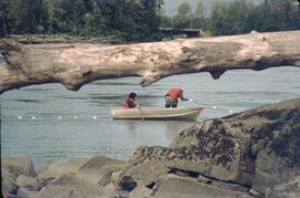 Two people pulling fishnets from rowboat at Terrace