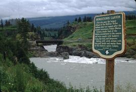 Moricetown Falls with "Moricetown Canyon" heritage marker sign