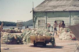 Three men working on Port Edward docks at Cassiar Cannery