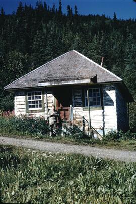 Gary Runka in front of old fort buildings at Dease Lake