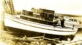 H. Welda standing in his boat Coaster in dry dock at Arrandale, BC