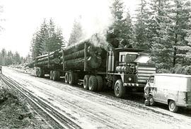 Fully loaded logging truck with two trailers