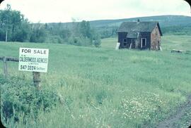 Farm with real estate sign near Smithers