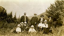W.H. Collison posing with children and grandchildren in meadow at Kincolith, BC