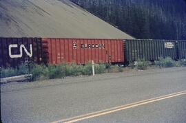Three train boxcars on railway near Terrace