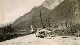 Poles, Crane, and Men on Road Construction Northern BC