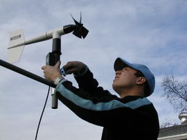 Student installing wind monitor