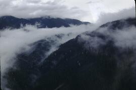 Clouds over mountains from helicopter at Natlan Creek