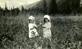 Young Marion and Joyce Collison in meadow at Kincolith, BC