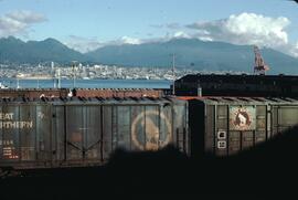 View of Vancouver from railyard with Great Northern Railway boxcars