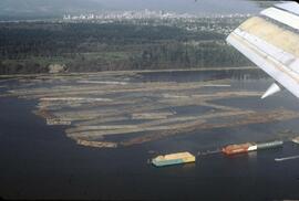Aerial view of downtown Vancouver and log booms on coastline