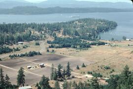 View of ferry, beach and farmland from mountain on Mayne Island