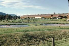 Large office building and storage facility by aeration lagoons near Vernon