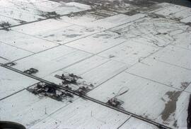 Aerial view of snowy rural area near Richmond in winter 1971